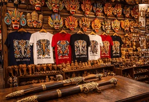 A souvenir shop with masks, T-shirts and wood carvings