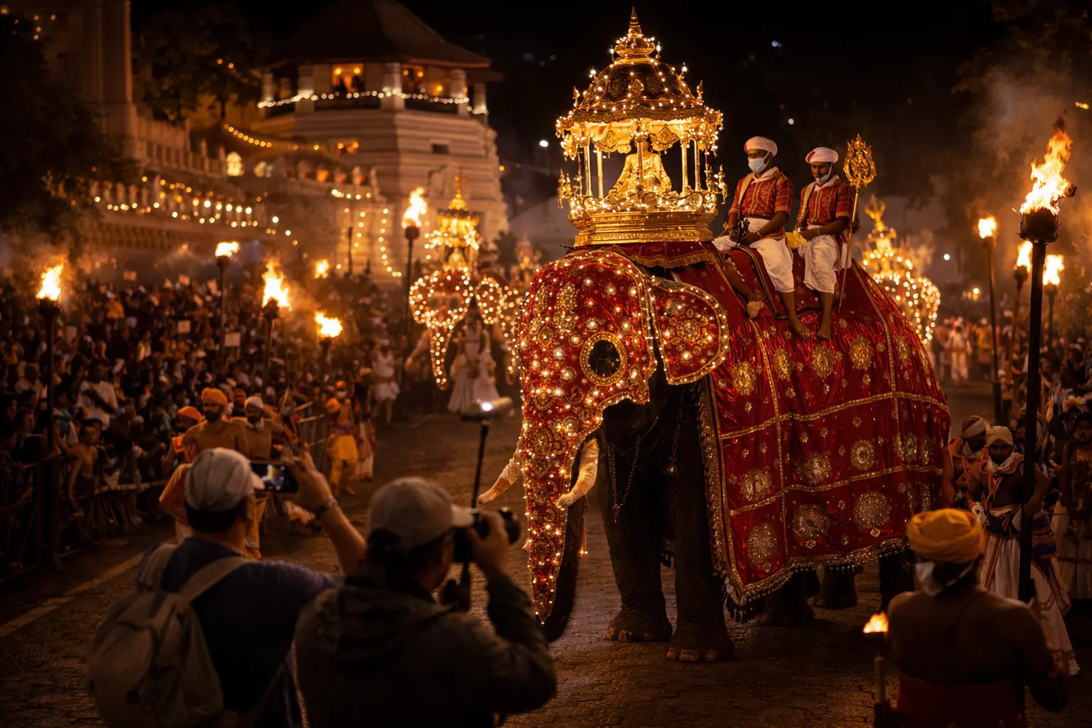 A decorated elephant in a torch-lit temple procession