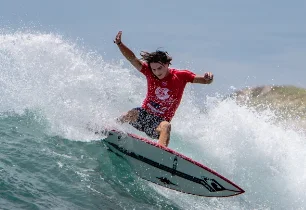 A guest surfing a breaking wave