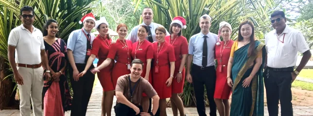 A large group celebrating Christmas with hotel staff
